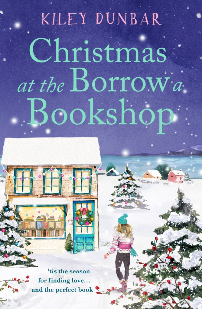 Book cover for Christmas at the Borrow the Bookshop.  A traditional bookshop in the snow with a Christmas wreath on the door and decorated with lights. A woman in a bobbly hate and jumper walking towards it. Christmas trees are in the foreground